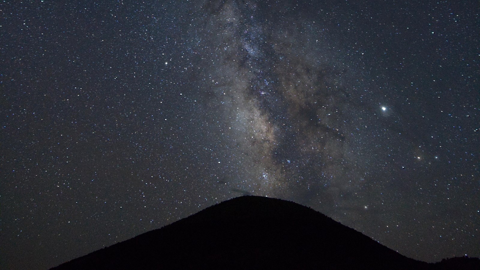 Stars in the Night Sky and the Milky Way over the shadow of Capulin Volcano