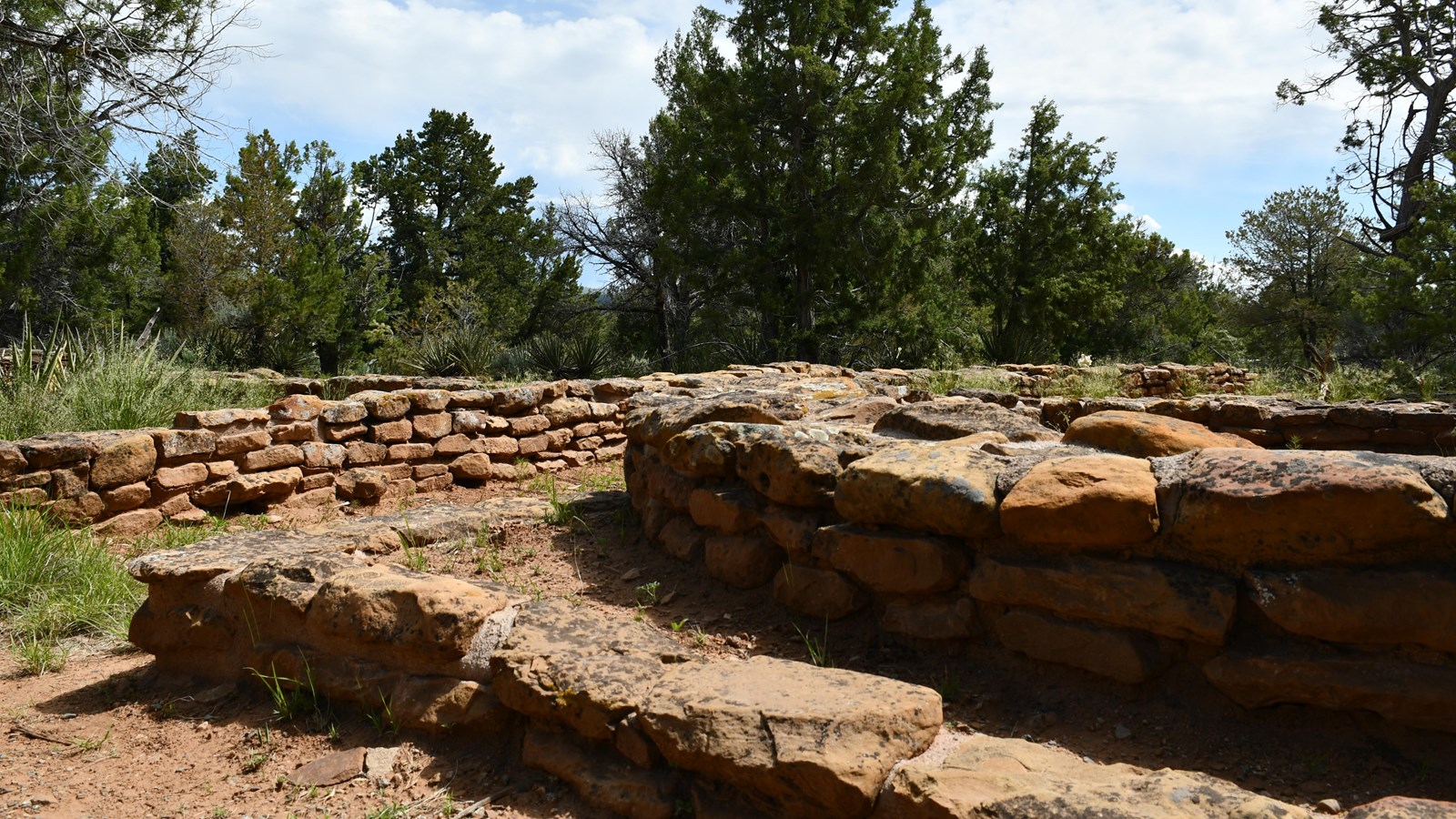 Blocks of sandstone compose low walls of an early Pueblo structure.