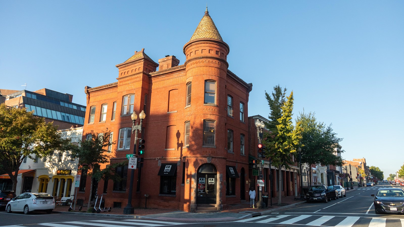 A large red building at an intersection of two roads.