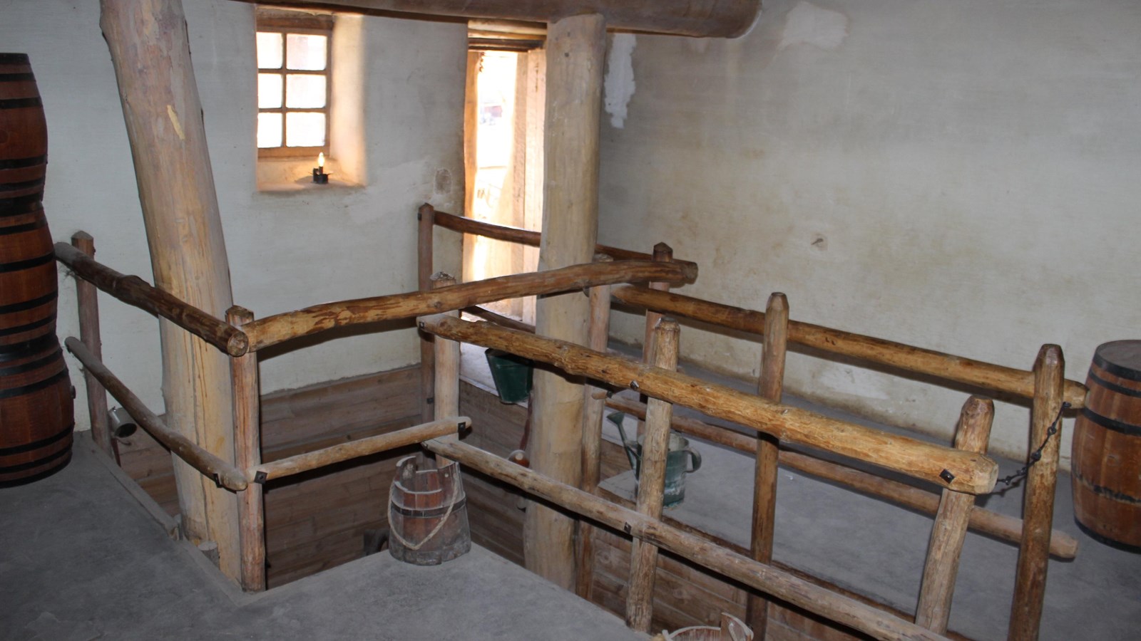An adobe room with a recessed well reached by stairs