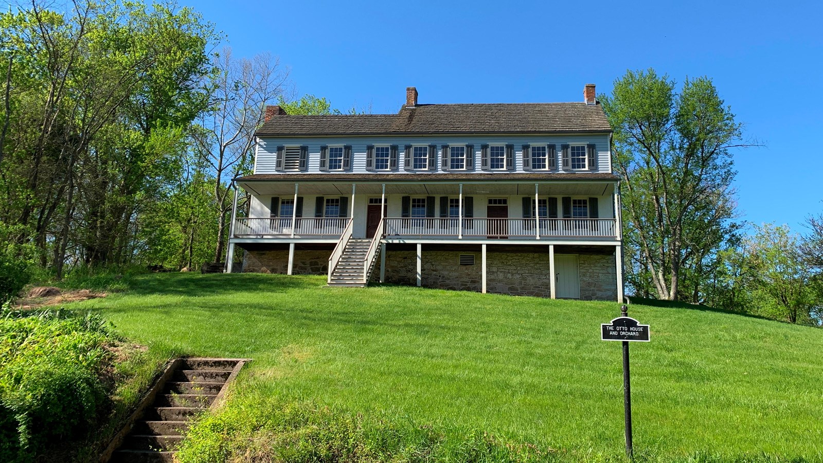 white house on a hill, two level with front porch