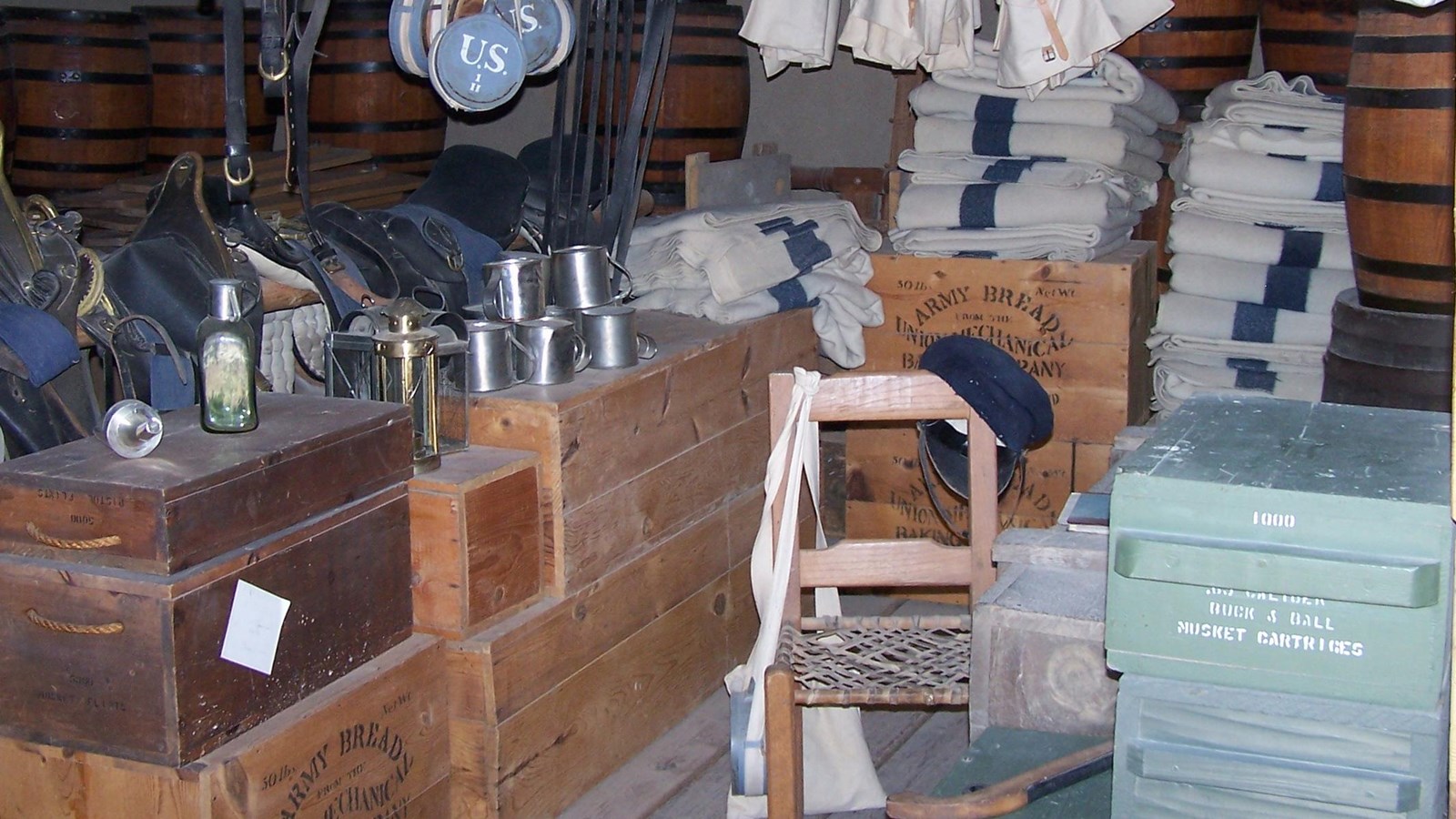 A room filled with wooden boxes and military equipment.