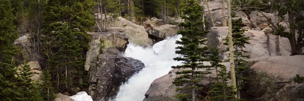 a waterfall flows over a rocky cliff