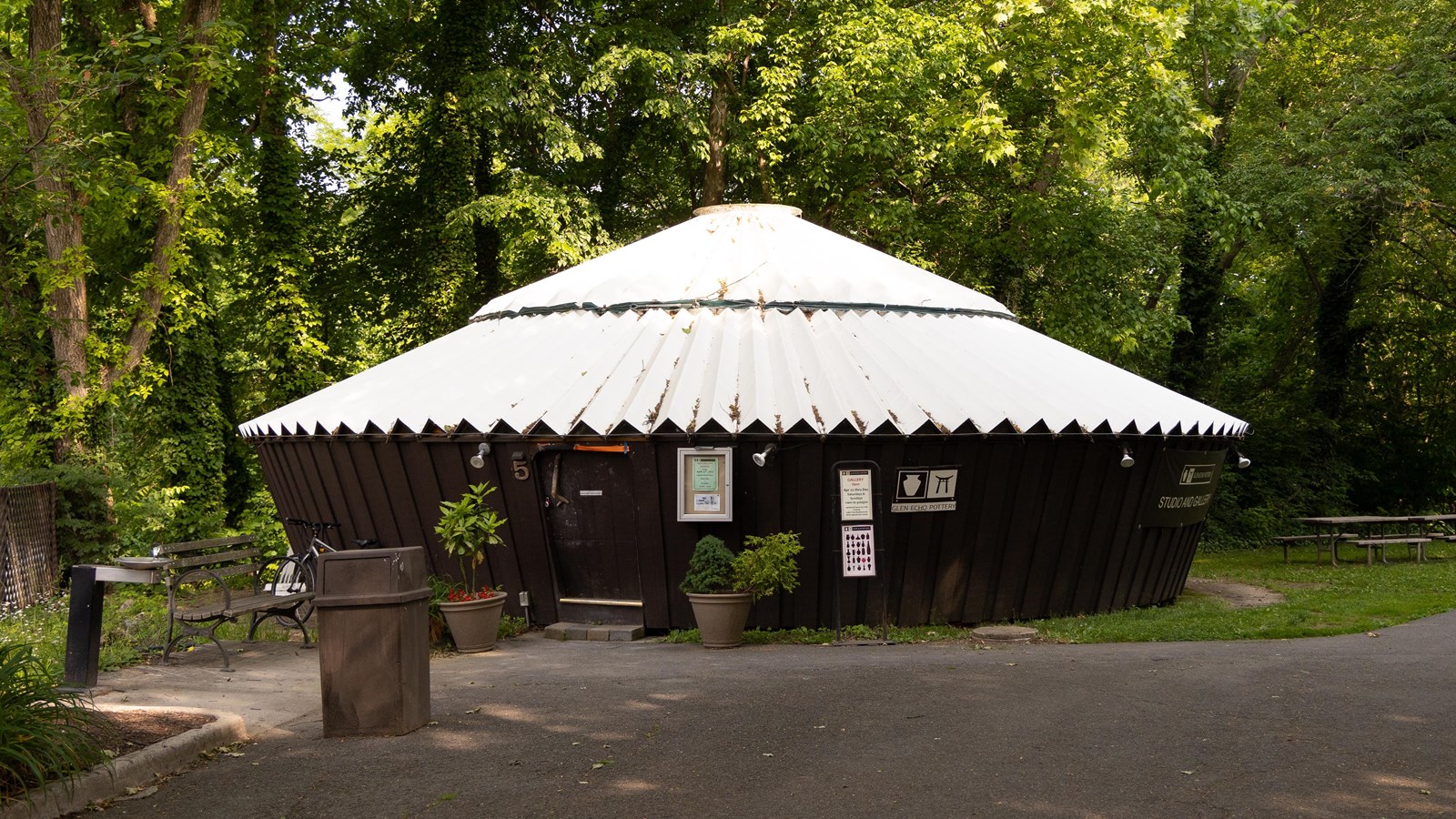 A round house with a cone-shaped, corrugated roof.