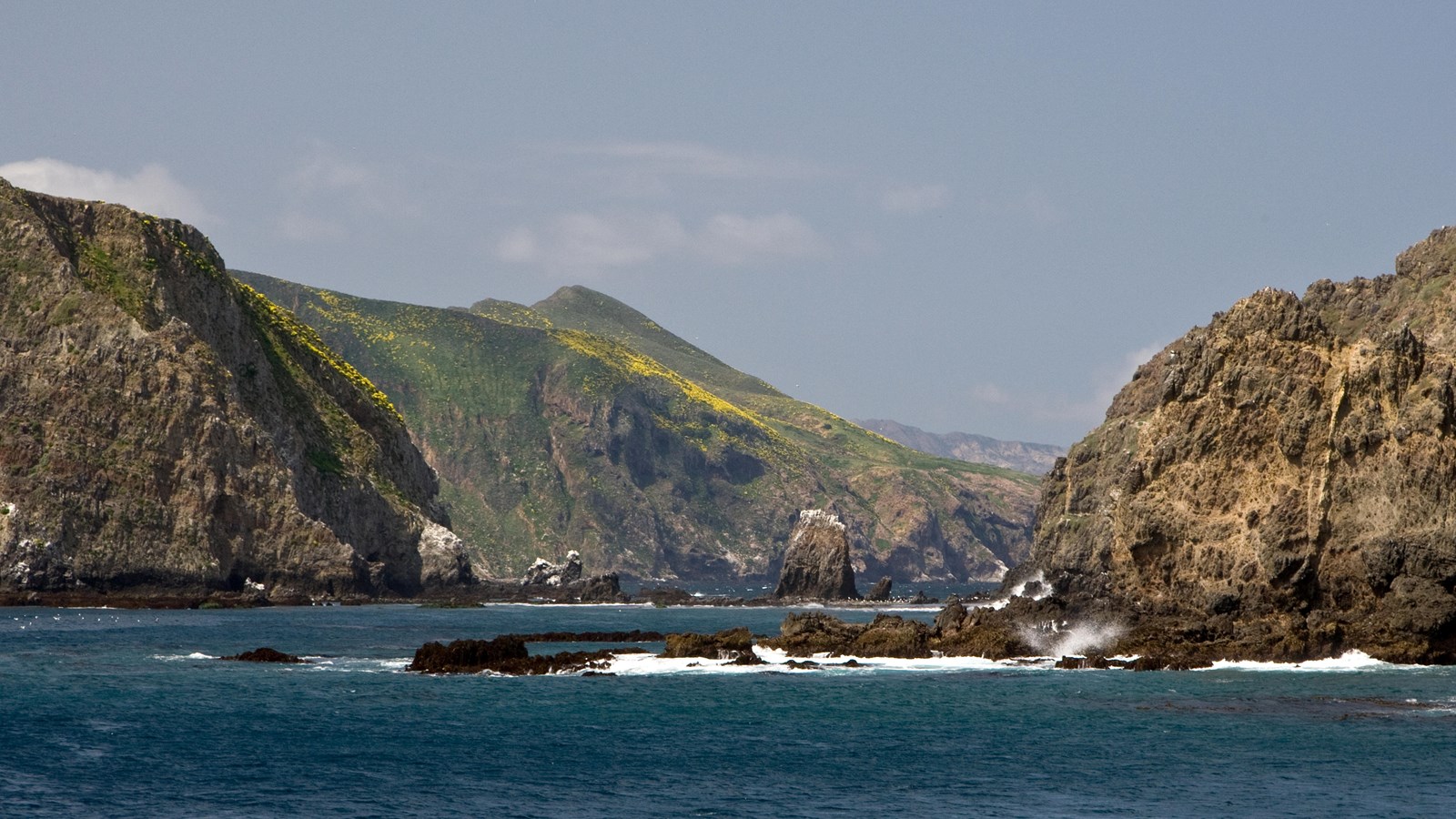 gap between two islets. rocky coast with waves.