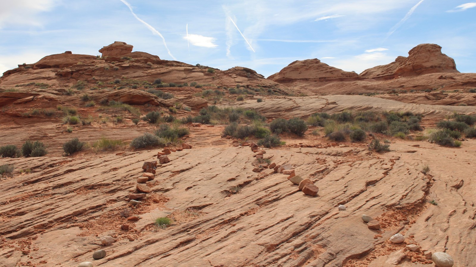 Group of sandstone buttes. Wide trail marked by small rocks