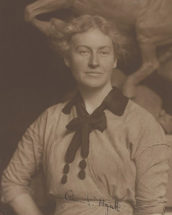 Sepia-tone photograph of Anna Hyatt Huntington. She is a white woman wearing a light-colored dress.