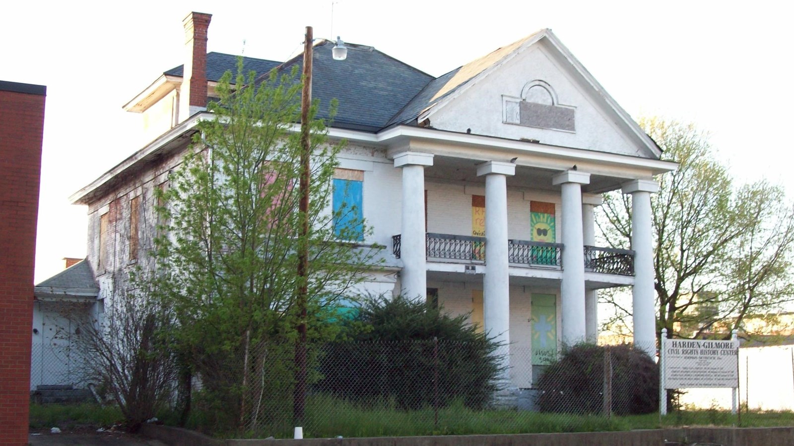 Two-story white house with columns. 