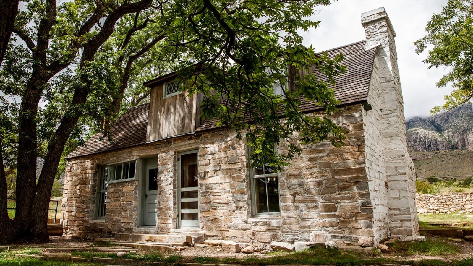 A house built with irregular stone walls painted white