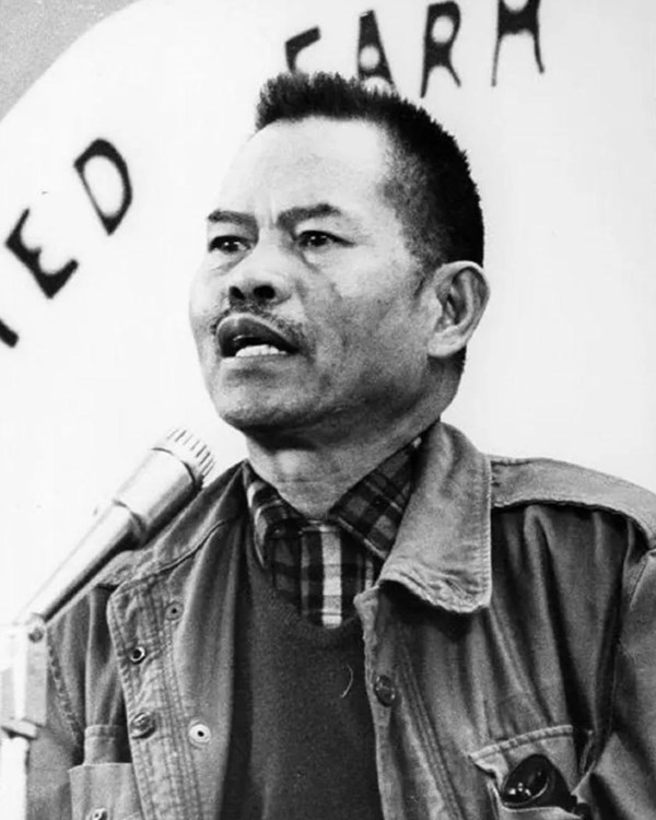 Portrait of Filipino man speaking into microphone at an event
