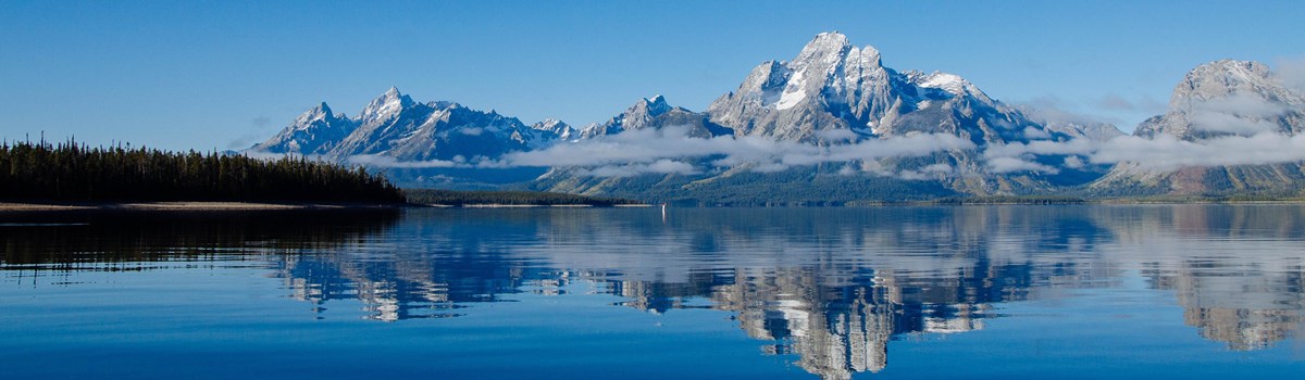 Mountains reflected on a calm lake.