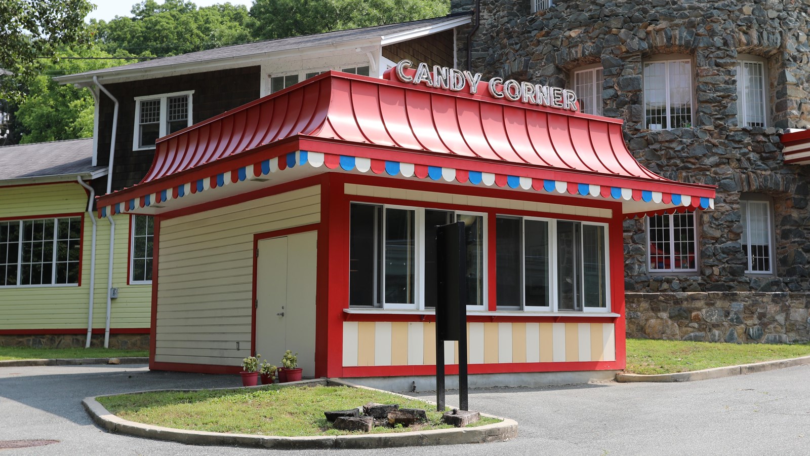A small, cheerful red building with