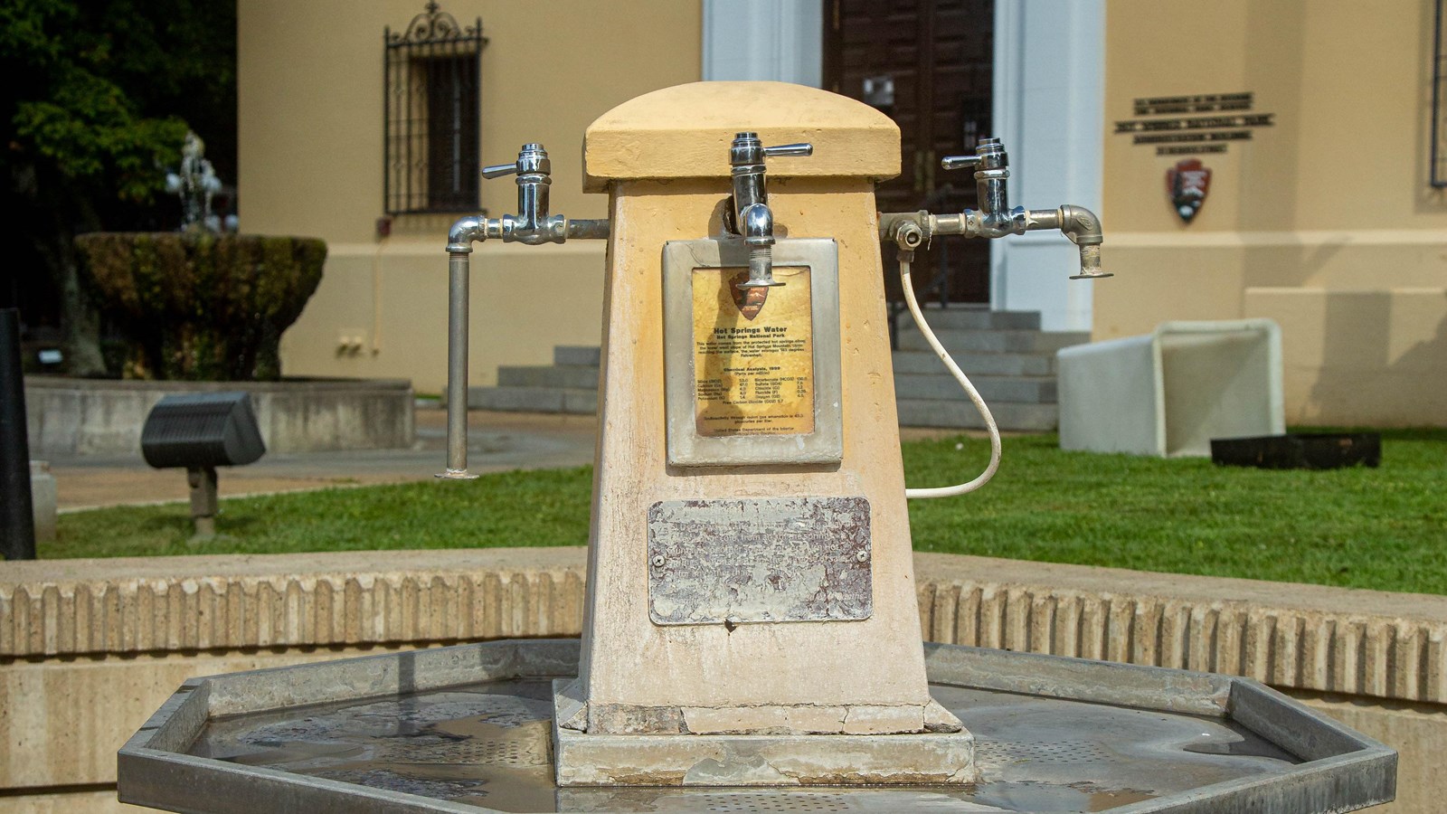 A water fountain with four spouts on each side 