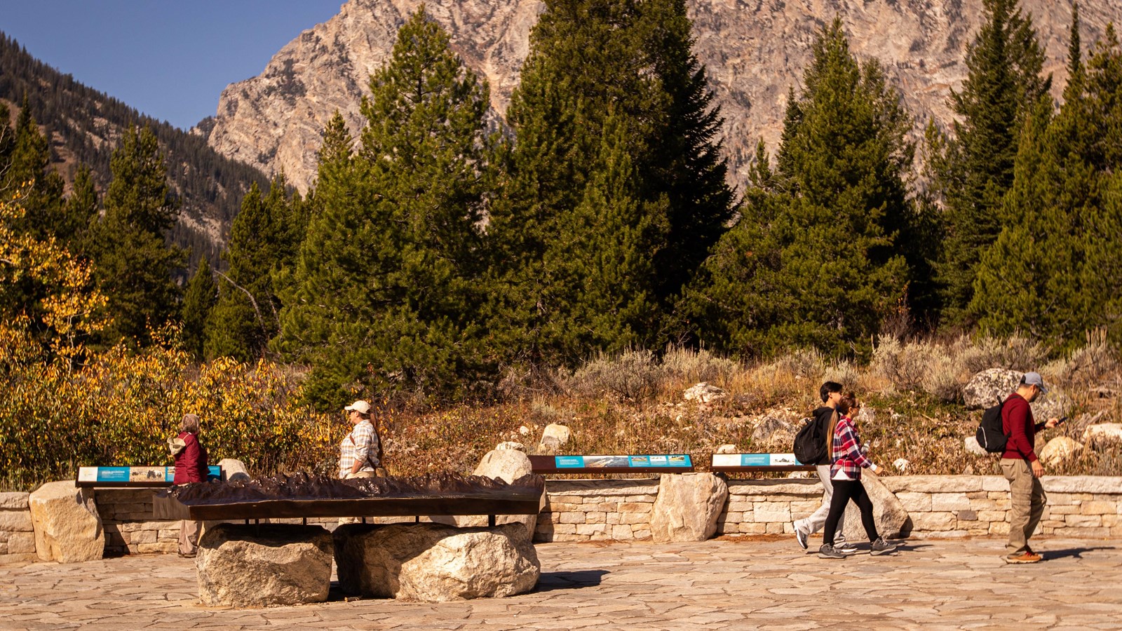 Interpretive signs and a bronze relief map in Jenny Lake plaza