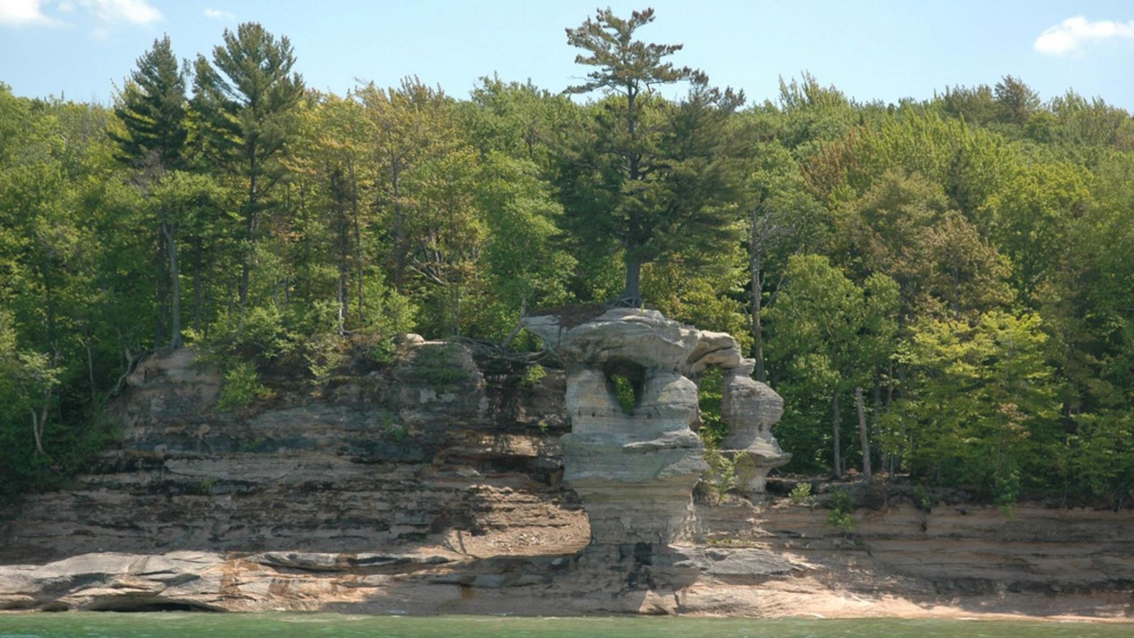 A lone pine tree survives atop Chapel Rock, an easily recognized formation of the Pictured Rocks.