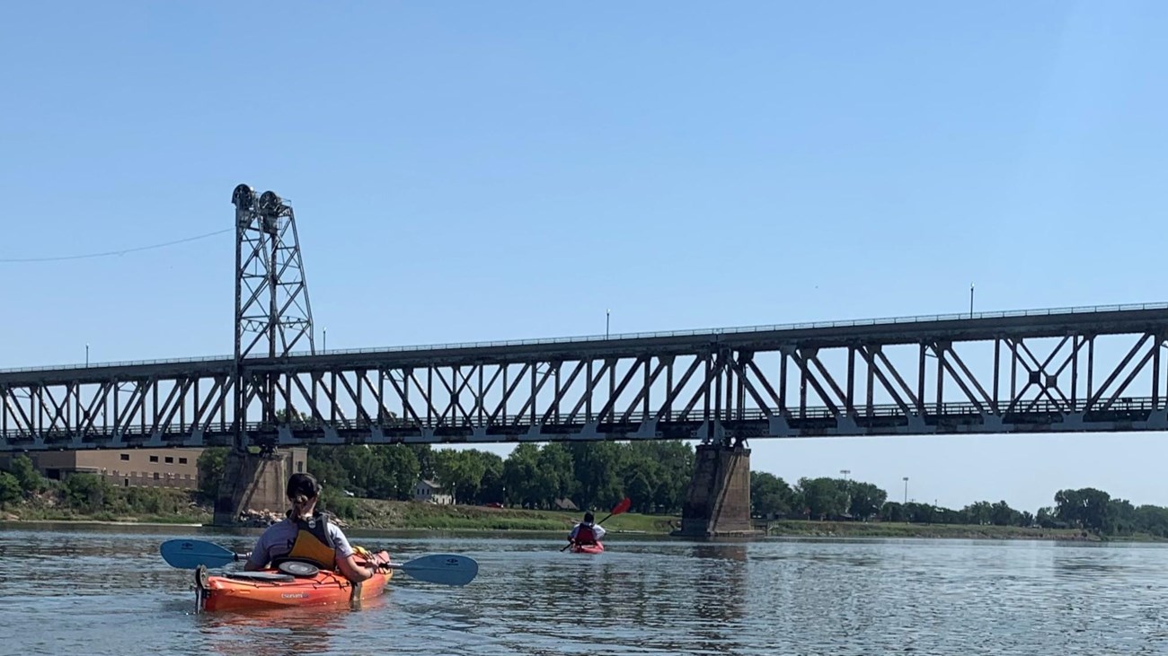 River ranger kayaking on the river near the Meridian Bridge on the Missouri River. 