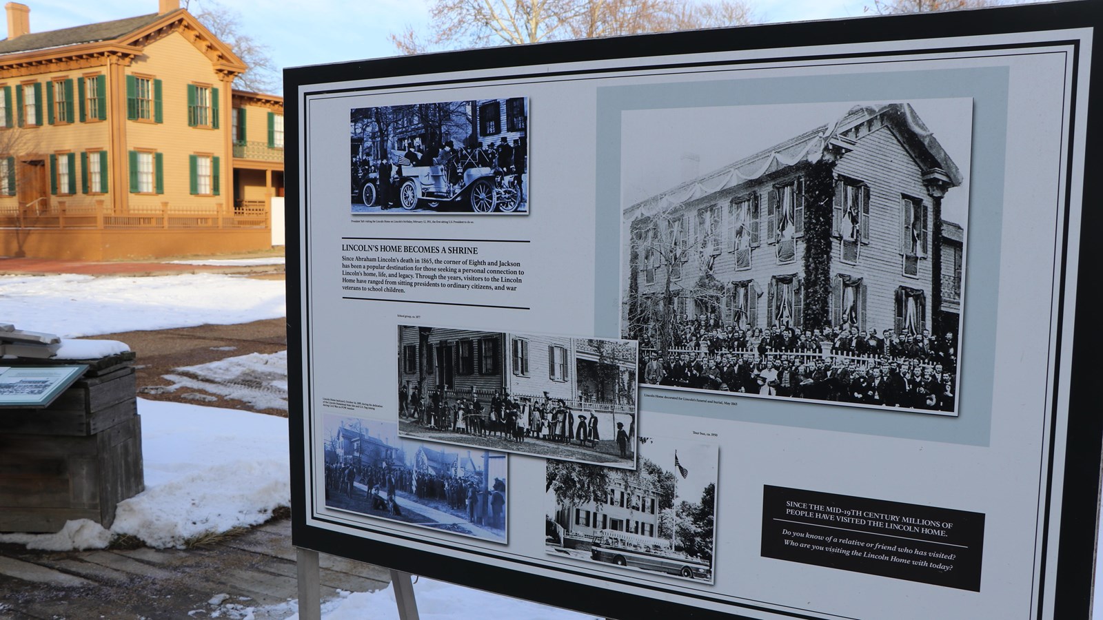 Large, upright outdoor wayside exhibit with Lincoln Home in the background. 