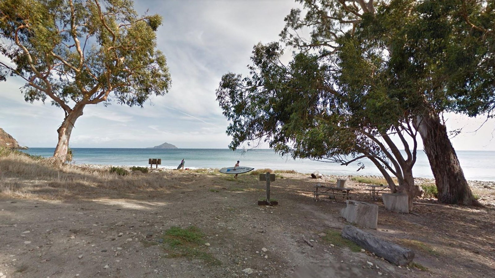 picnic tables along cobble stone beach