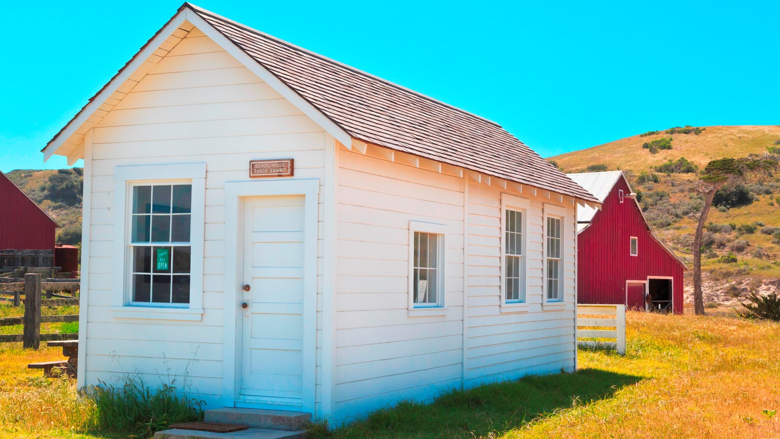 small white house with picnic table to the side