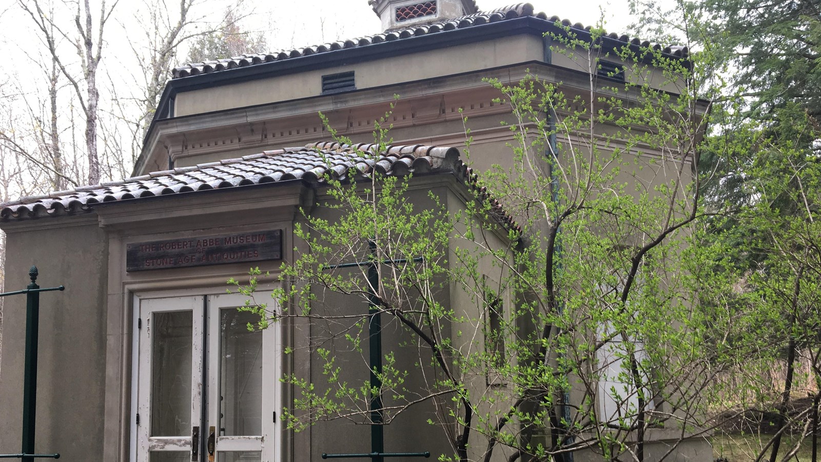 Historic museum building with a tree next to the front entrance