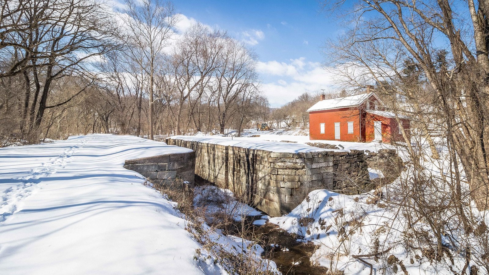Lock 31 cuts through snow covered ground. A brick lockhouse sits to the right.