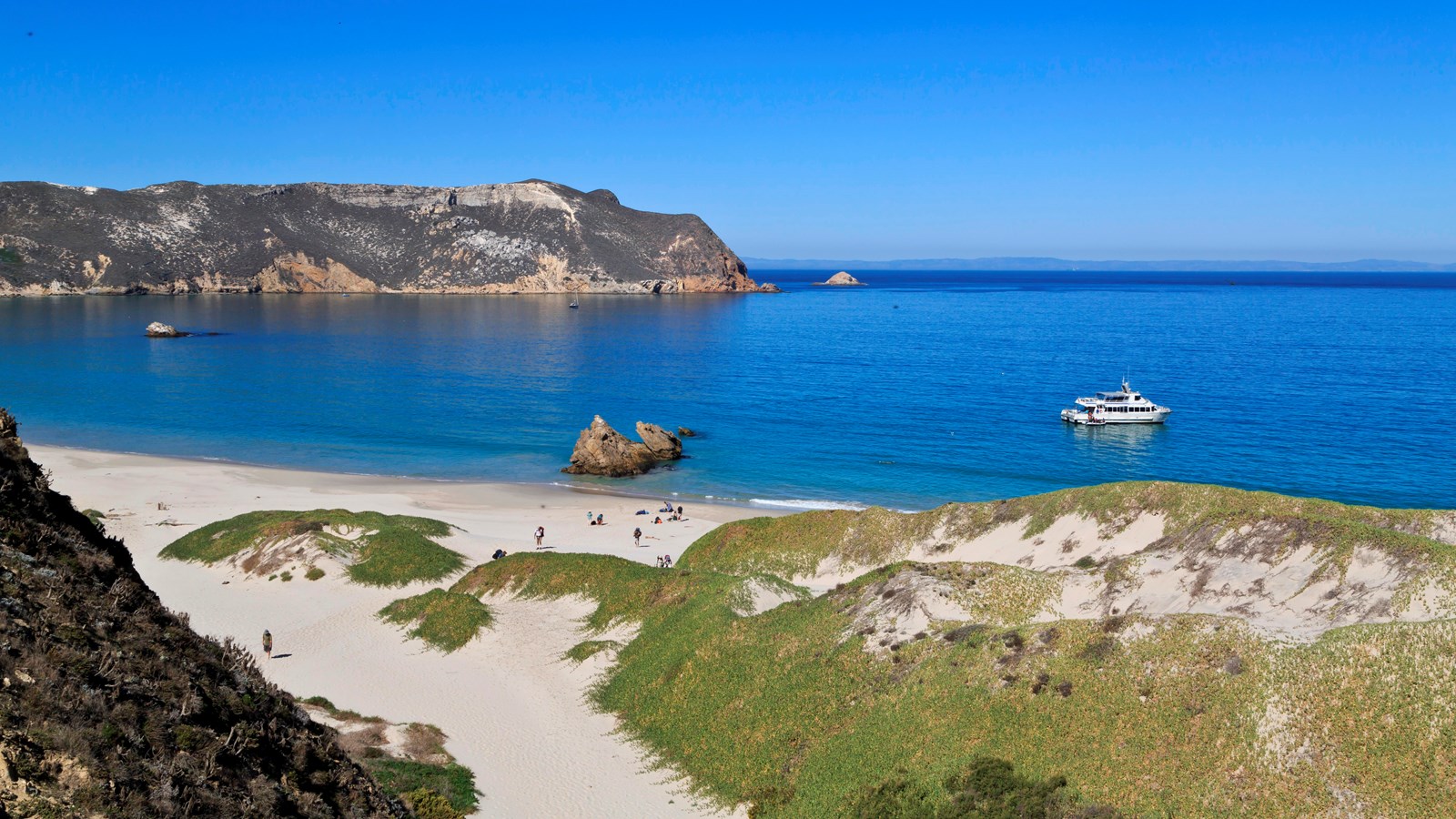 white sand beach in crescent shaped harbor