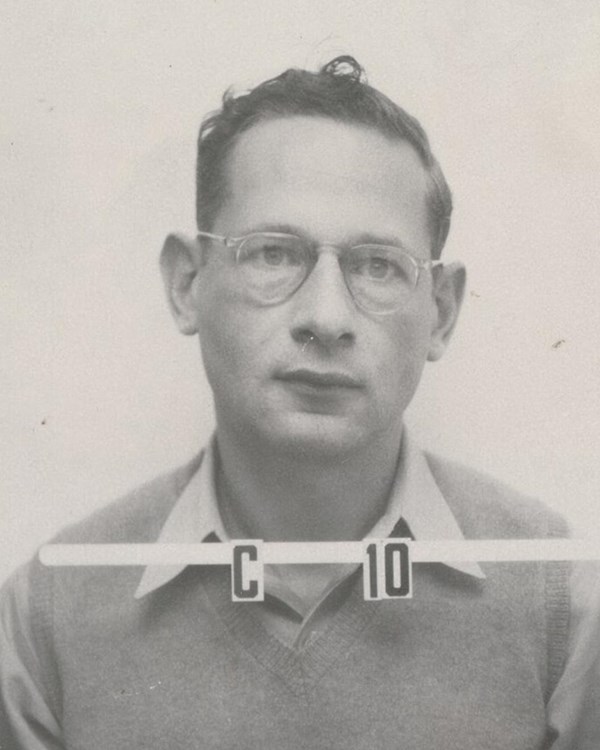 Black and white identification photo of a young man with short hair and glasses; ID number C10.
