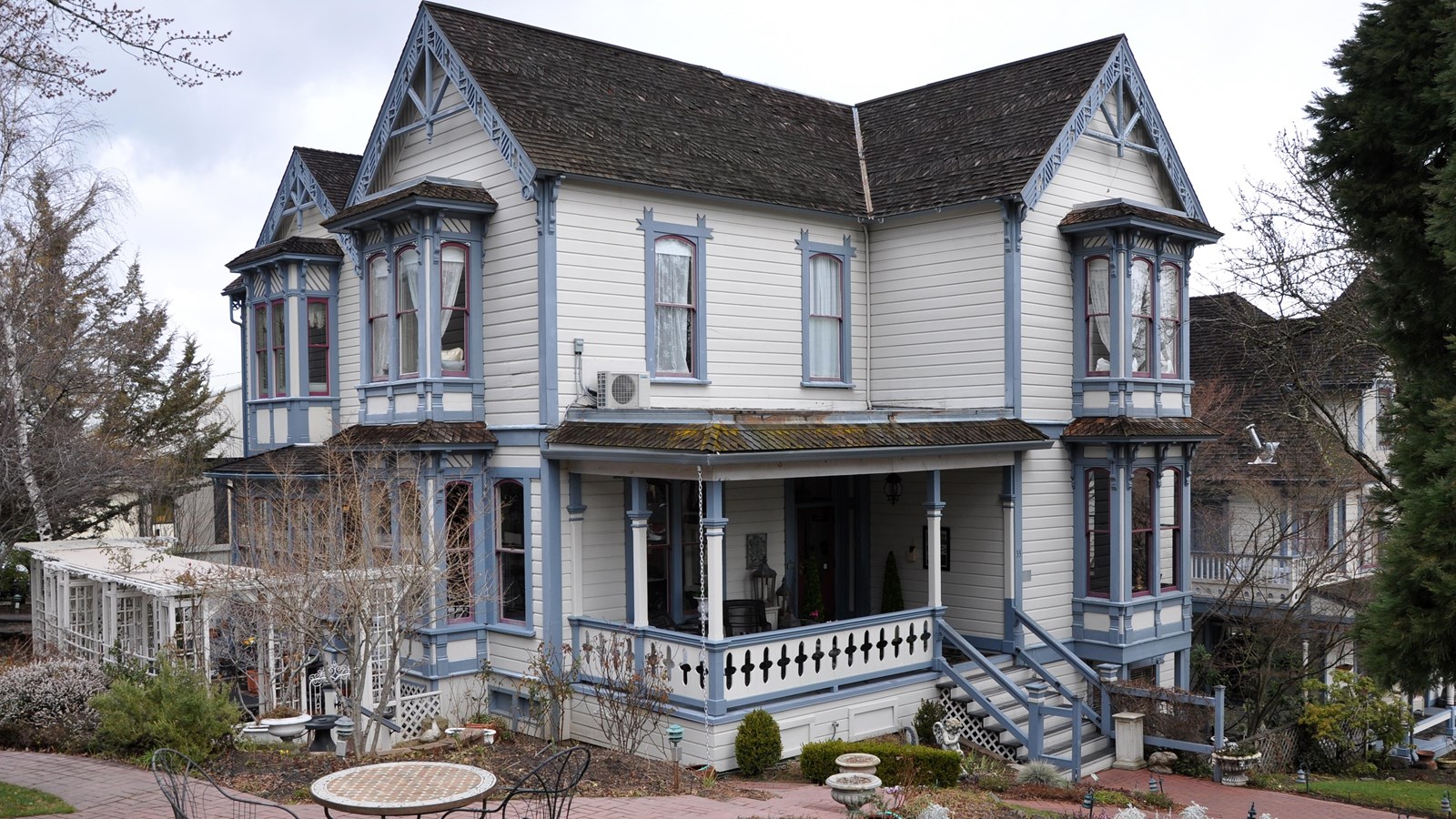 Two story white house with porch. 