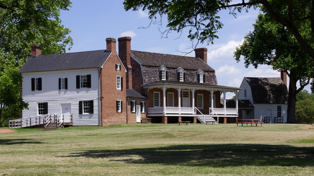 A two story brick building with two attached side buildings.