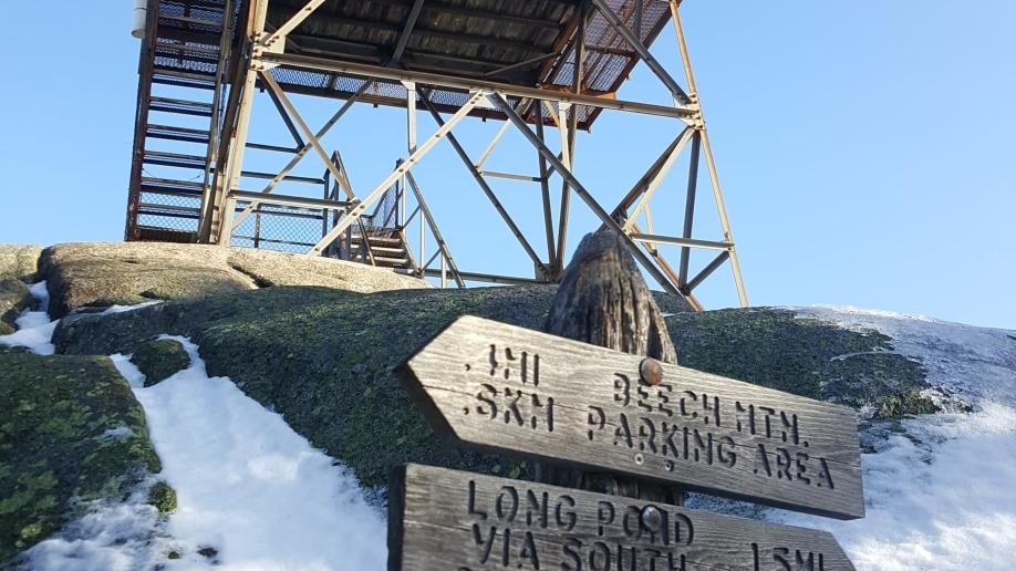 Beech Mountain summit sign with the fire tower behind