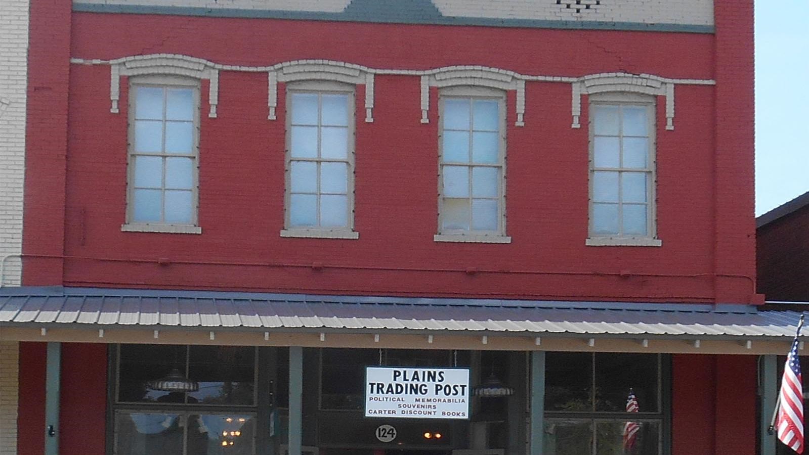 a red brick building with Plains Trading Post on a sign in front