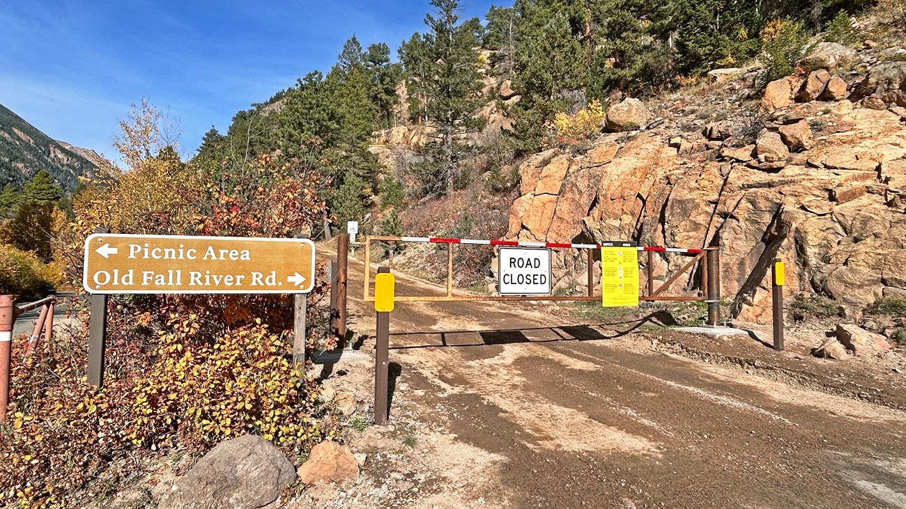 A gate is closed across the entrance to Old Fall River Road