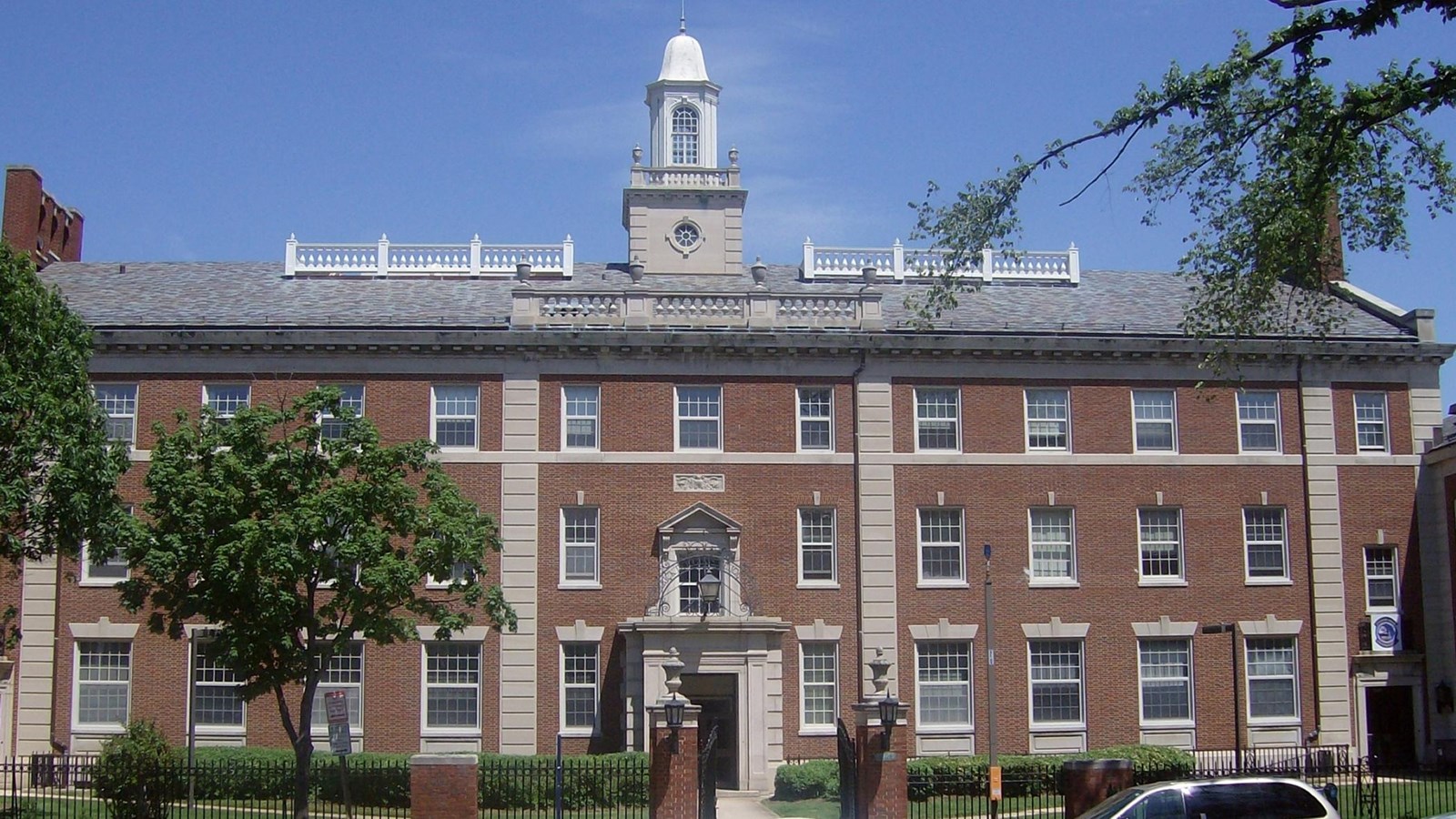 Three photos of brick campus buildings. 