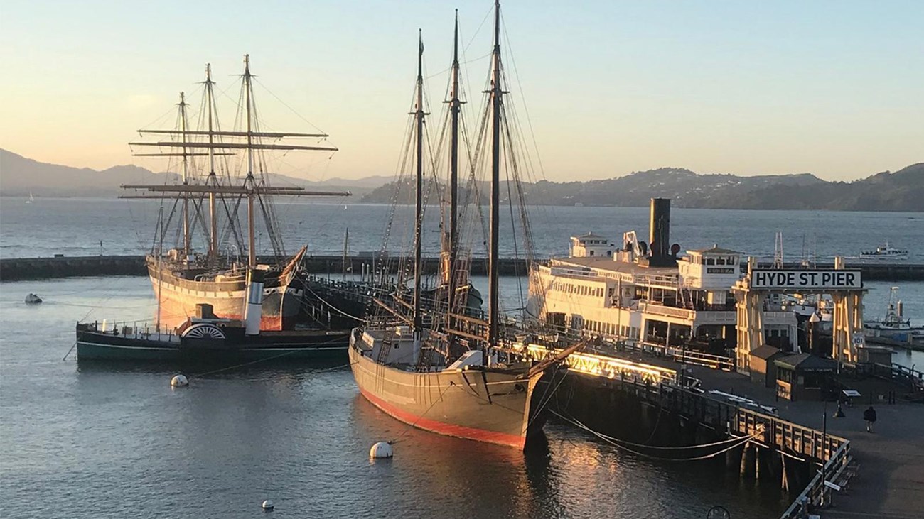 Several historic ships docked to Hyde Street Pier