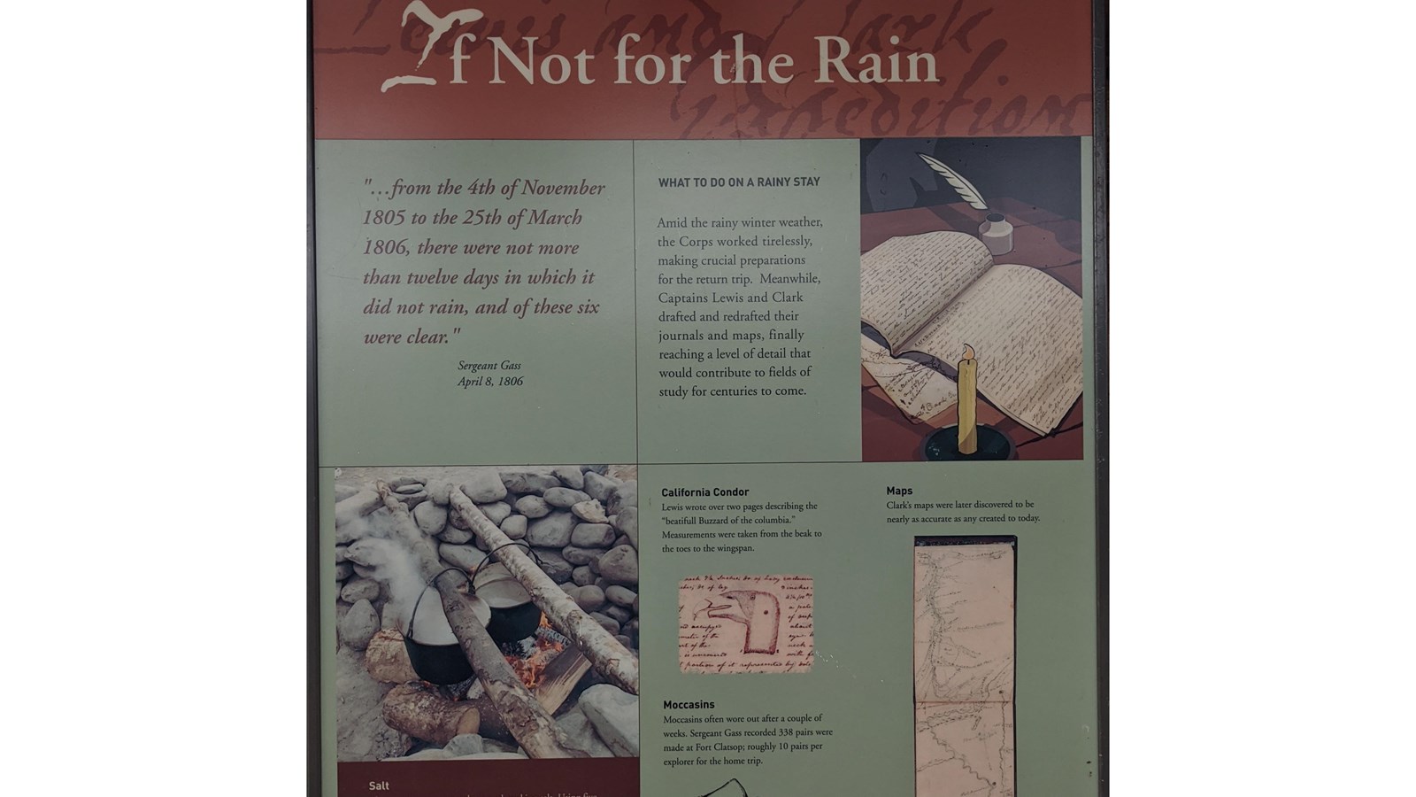 A large rectangular sign sits on wooden slats, the sky above the sign in an open air shelter.