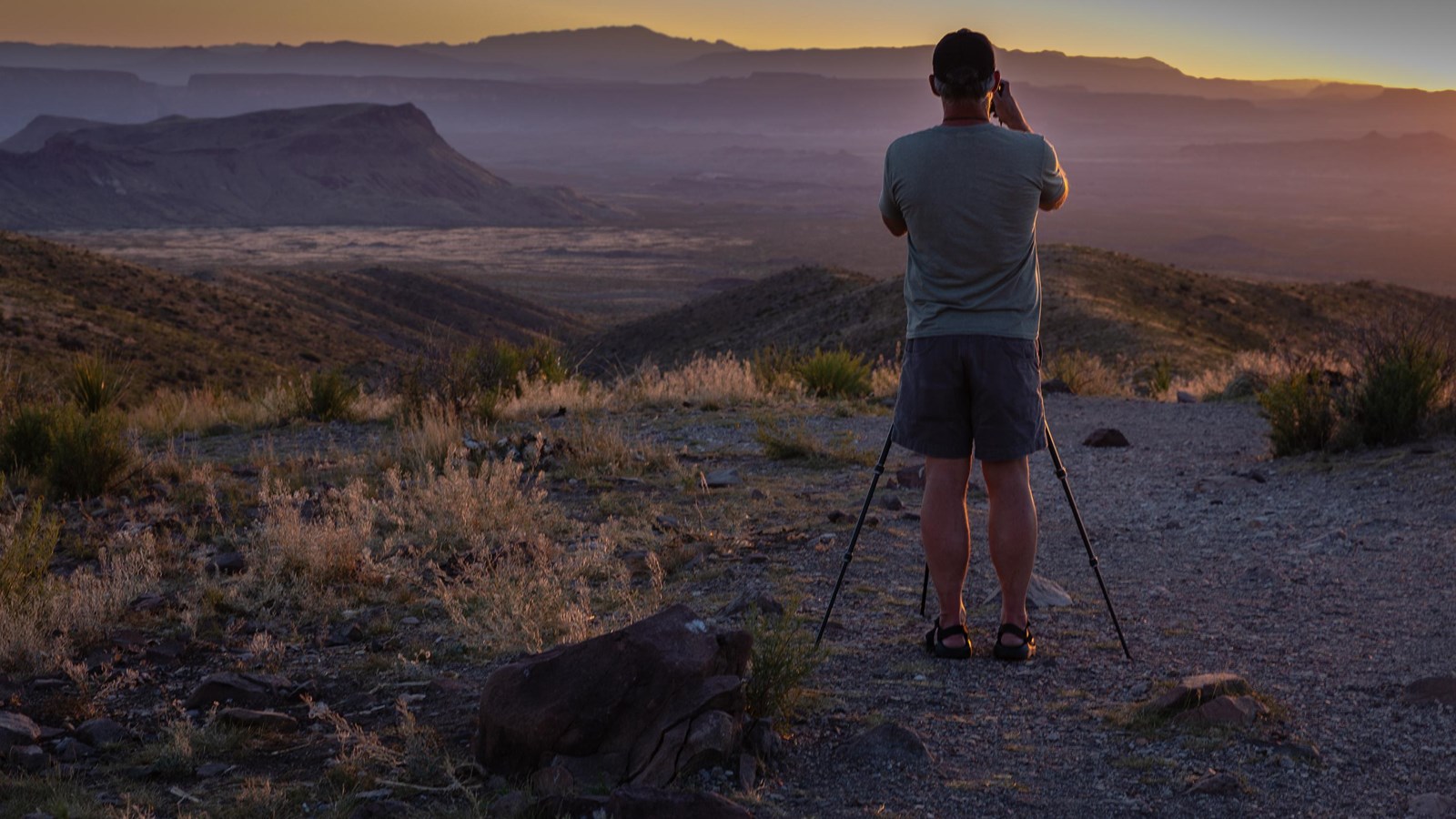 A photographer captures images of the sunset from Sotol Vista.