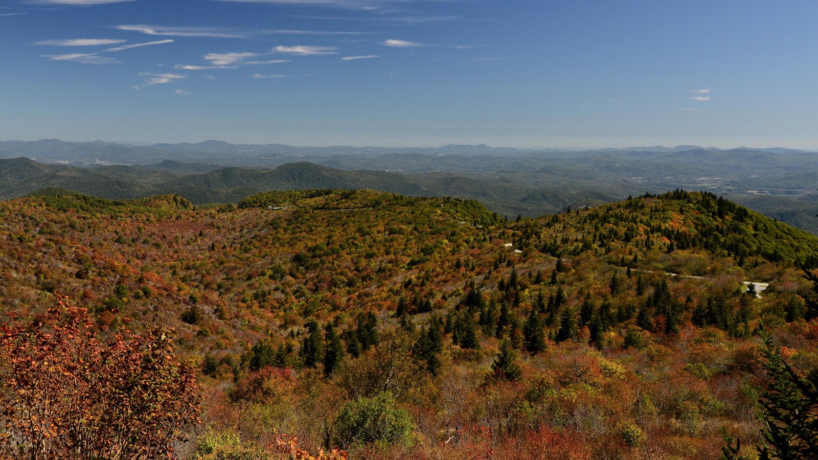 View of Graveyard Fields Valley with fall colors and layered mountains in the background