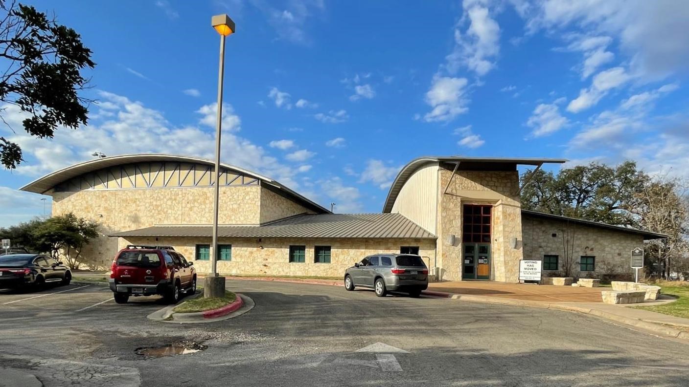 Yellow stone building with curved roof against a blue sky