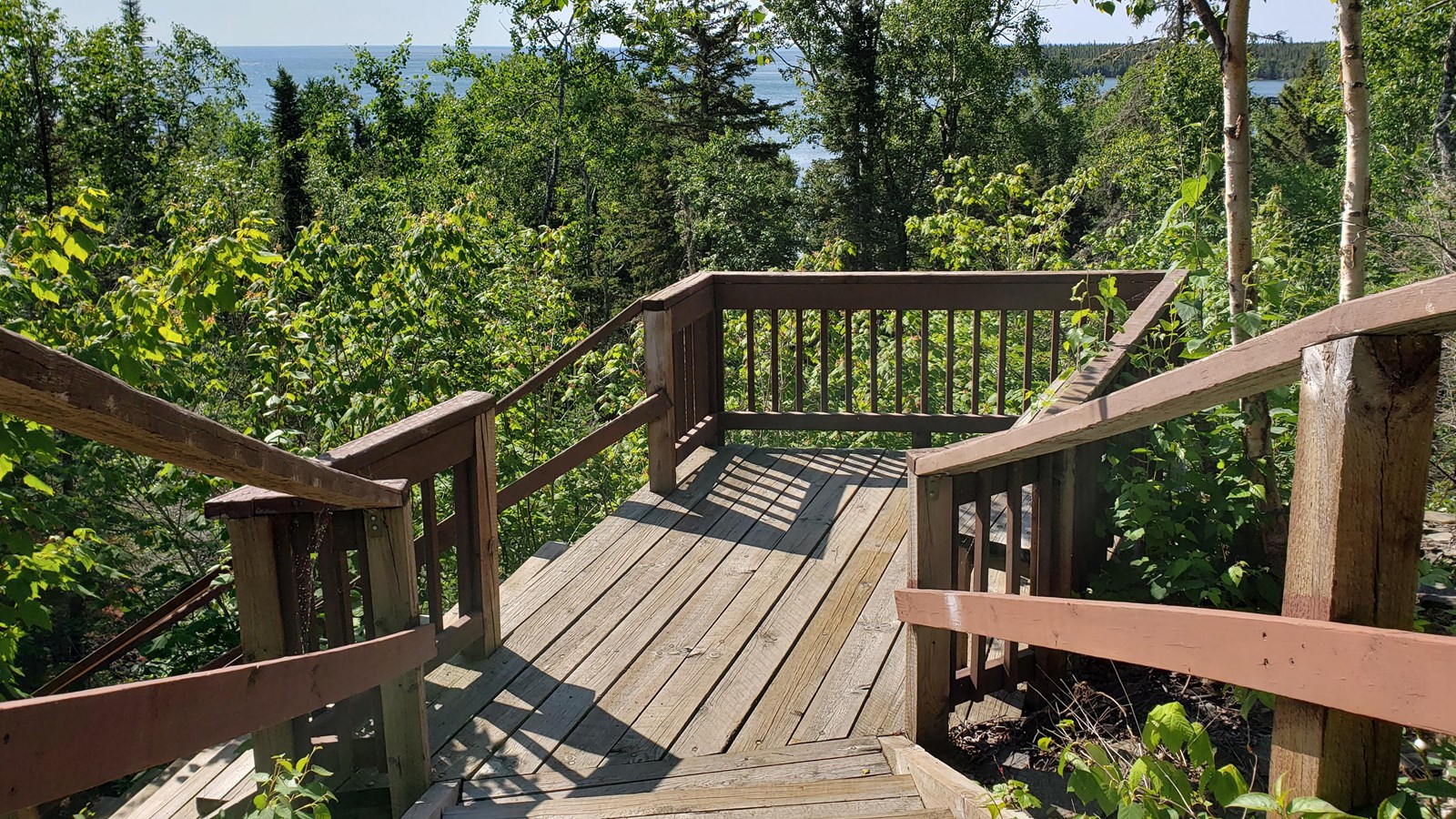 A wooden platform with wooden bannisters.