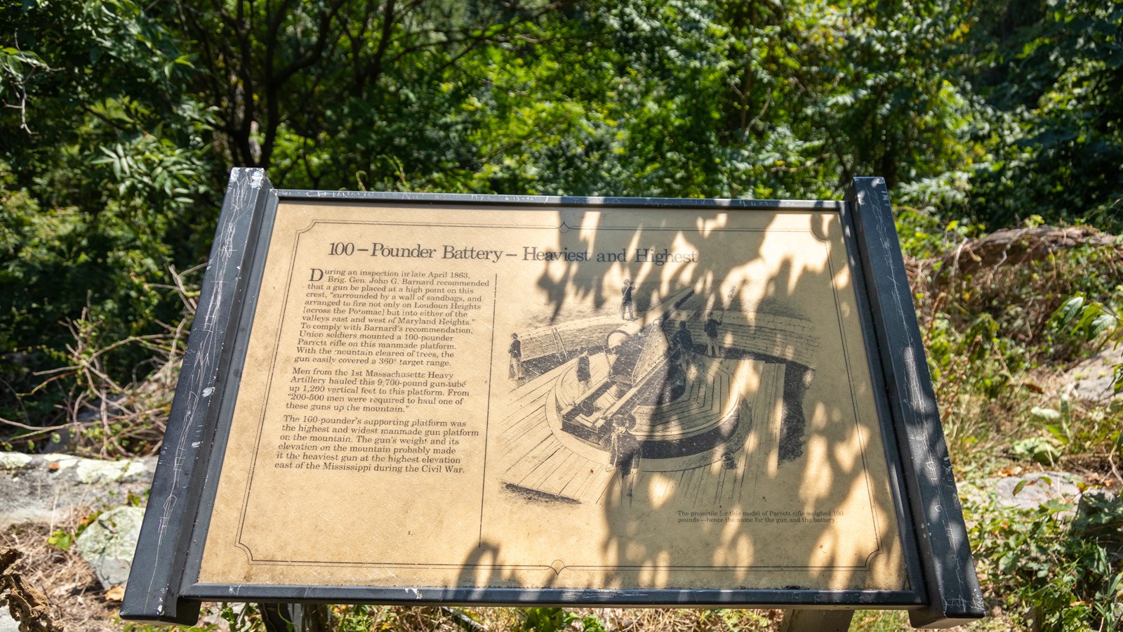 A sign on a rocky ledge describes the heavy gun placed here to give a 360-degree target range.