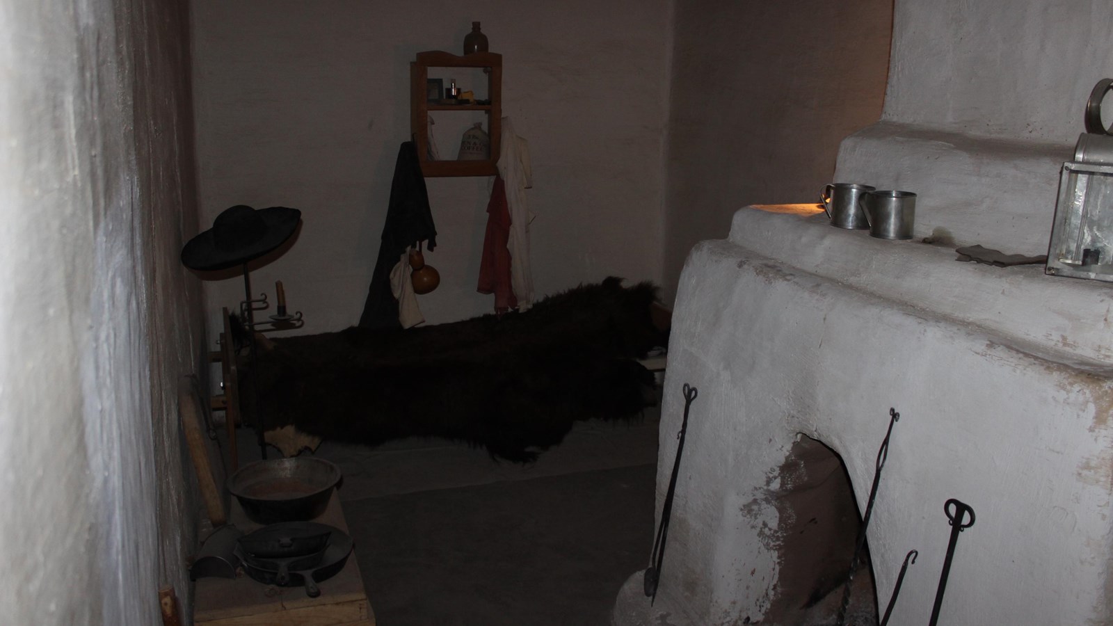 A narrow room outfitted with a bed