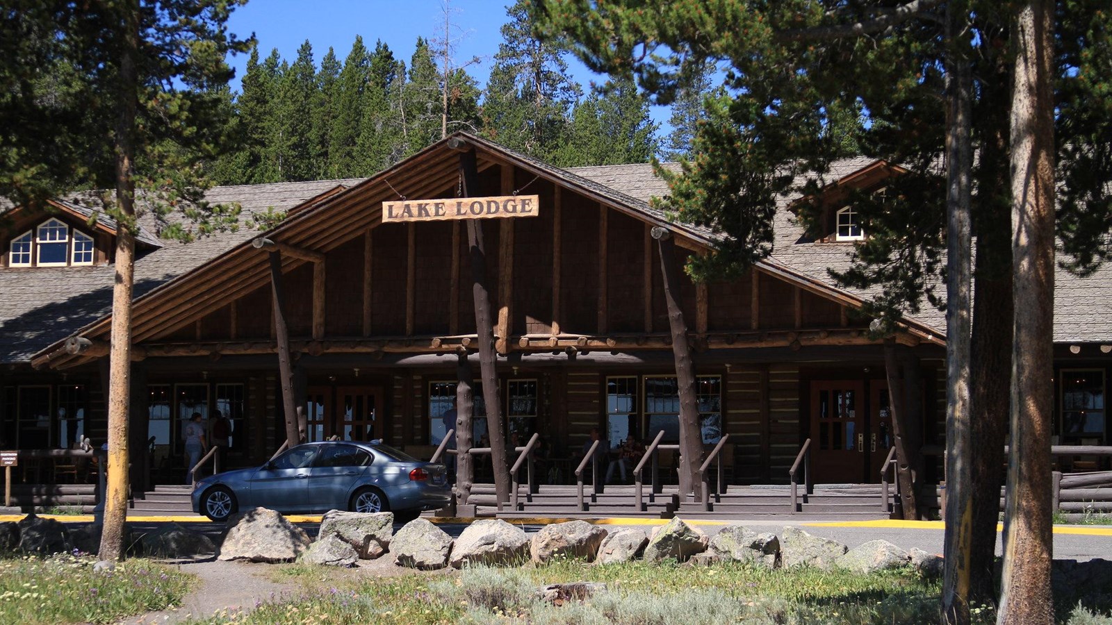 A large, log cabinlike building with a large porch.