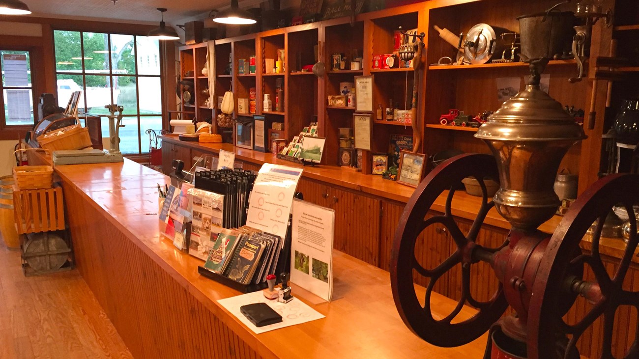 Shelves filled with historic items and an old coffee grinder on counter.