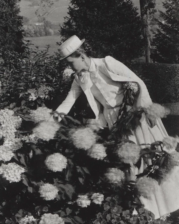 woman reaching for flower