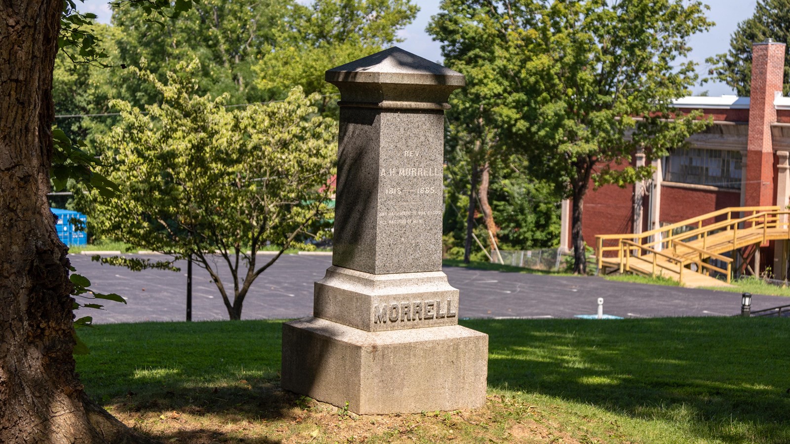Vertical, 4-sided, granite pillar monument. 