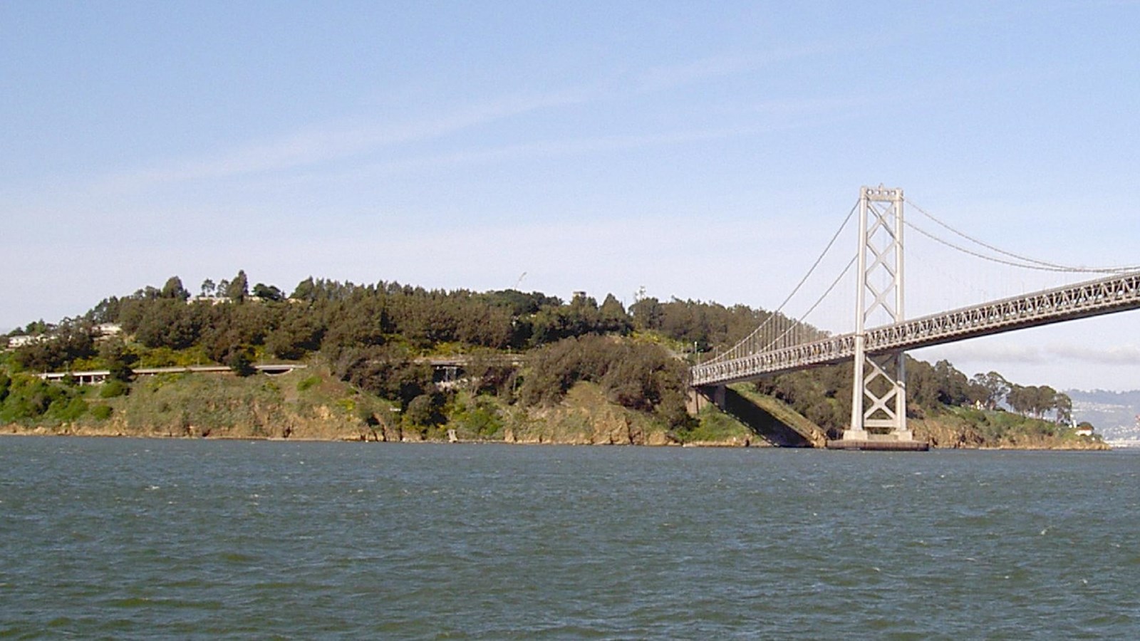 Photo of island next to a bridge. 