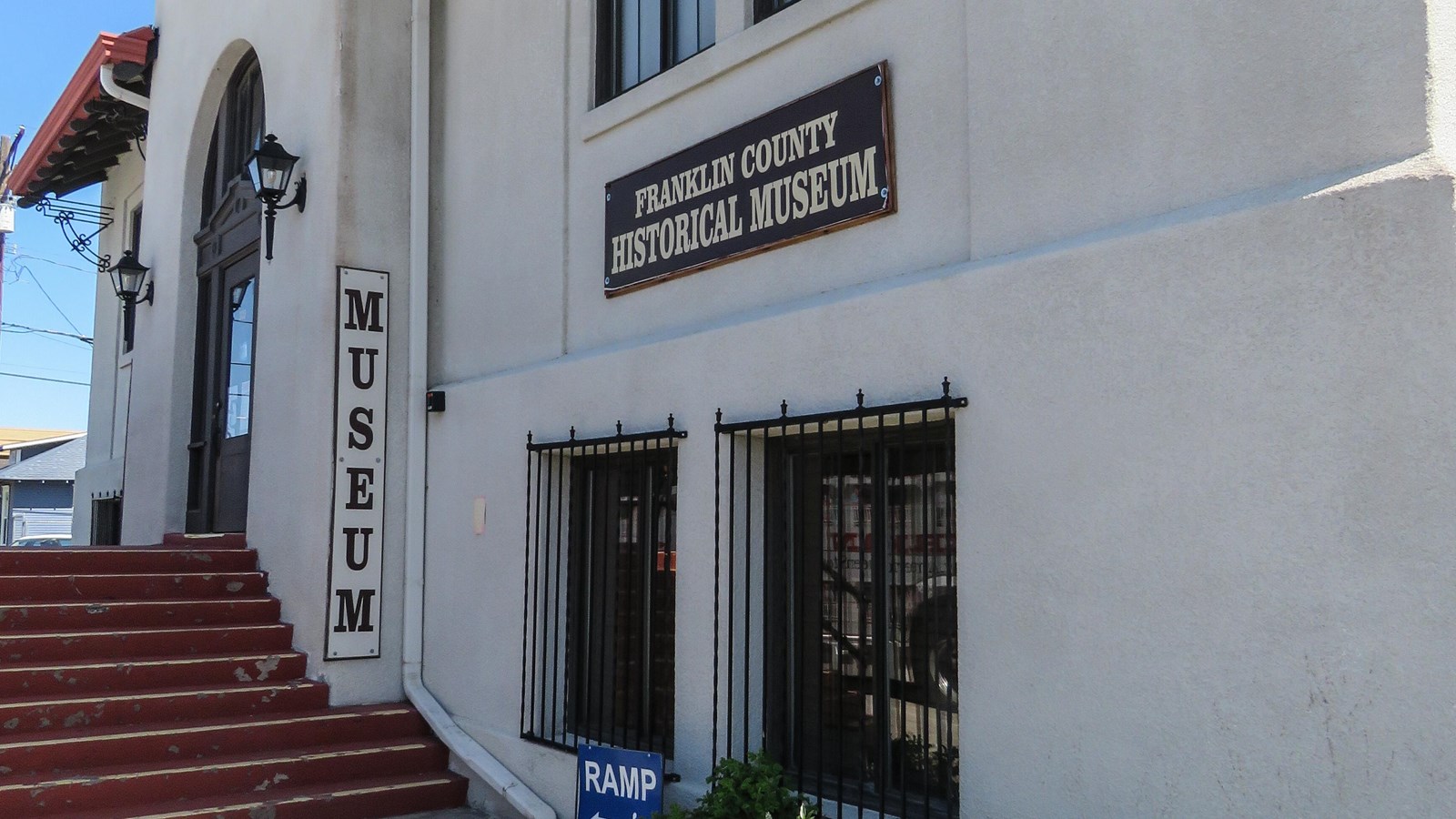 Color photo of a white building with a sign that reads “Franklin County Historical Museum.”