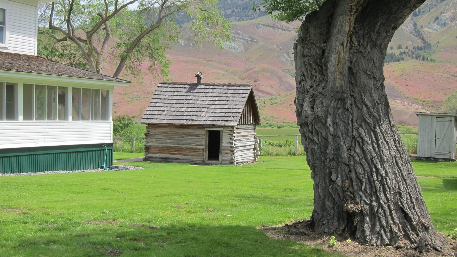 A small log house next to the ranch house.