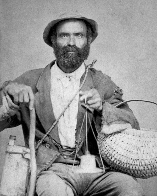 A black and white photo of a man sitting in a chair.