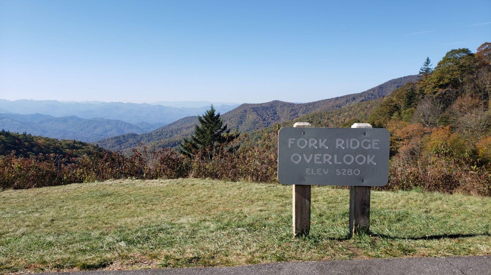 A Fork Ridge Overlook sign with miles of layered mountains in the background